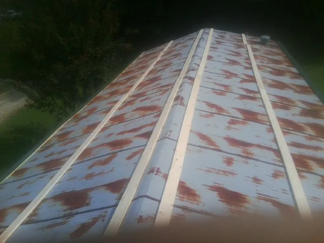 Rusted metal roof panels with new wood purlins before replacement — Storm Damage Roof Repair in Markham by Roofing Brothers